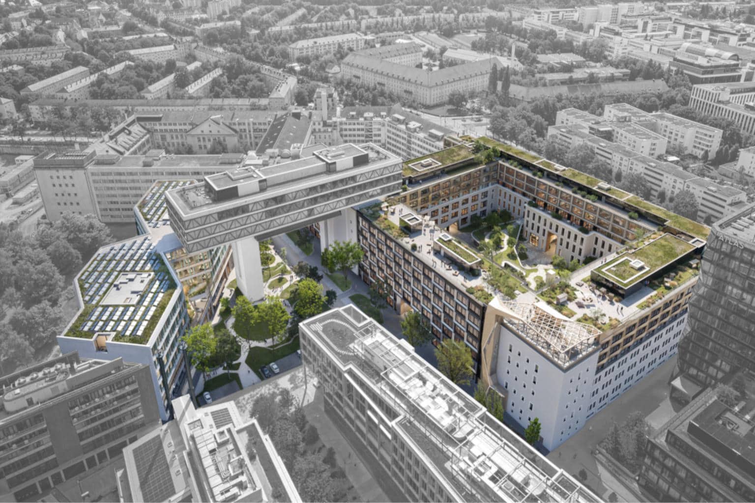 Luftaufnahme eines modernen Bürokomplexes mit begrüntem Innenhof und Dachgärten in der Stadt.
